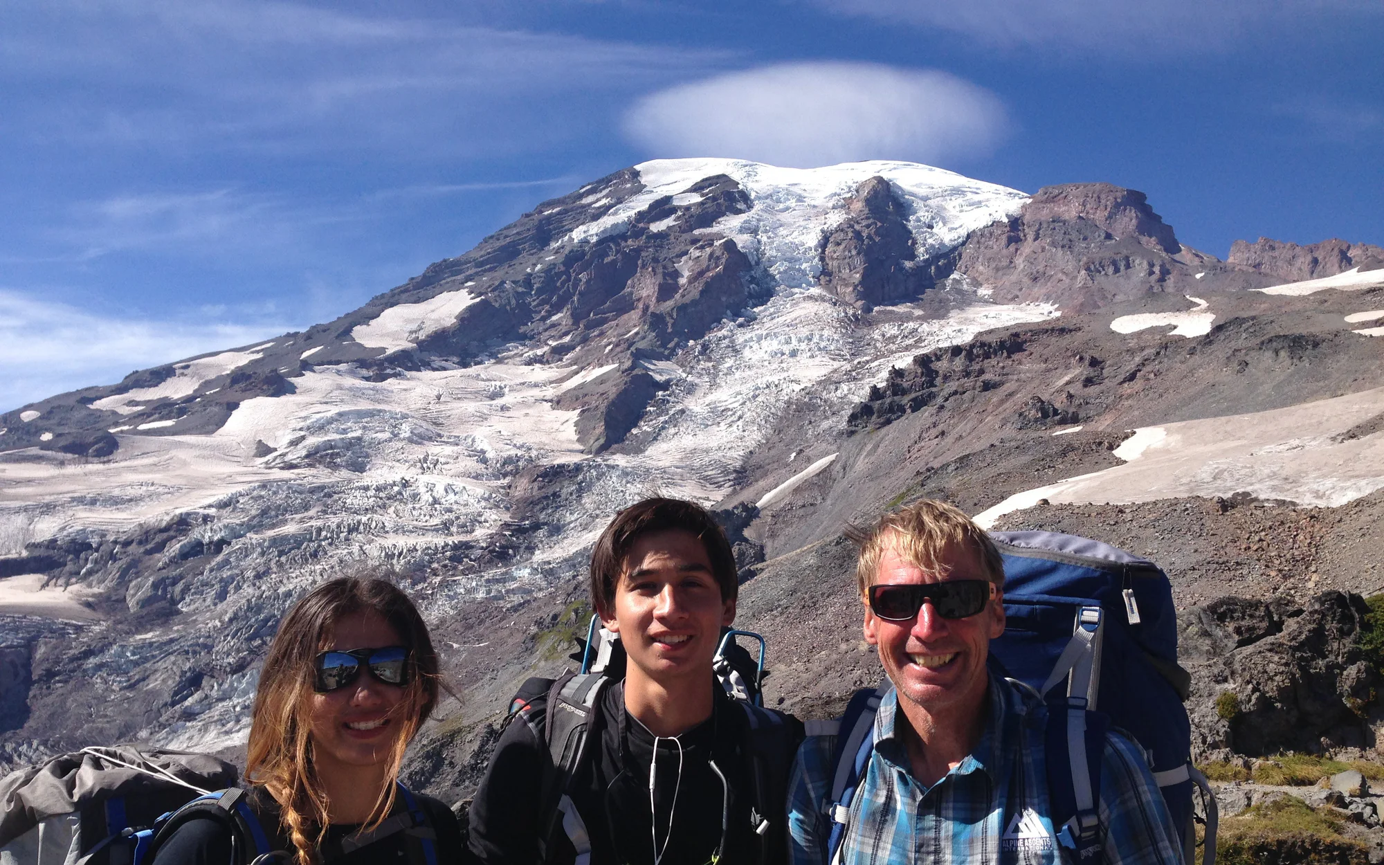 Craig Van Hoy with two climbers beneath Mount Rainier